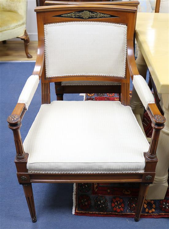 A set of eight French Empire style cherry wood dining chairs, ebony and ormolu mounted (two with arms)